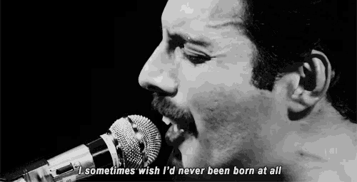 a man singing into a microphone with the words " sometimes wish i 'd never been born at all "