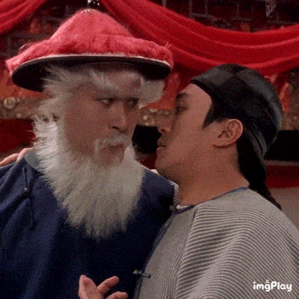 a man with a beard and a hat is standing next to another man .