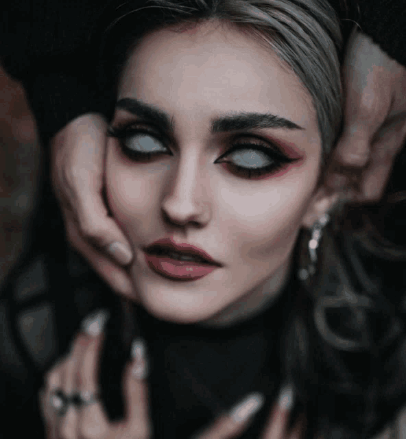 a close up of a woman 's face with white eyelashes