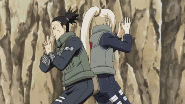 a man and a woman are standing back to back with their arms crossed