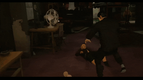 a man in a suit is kicking another man 's head