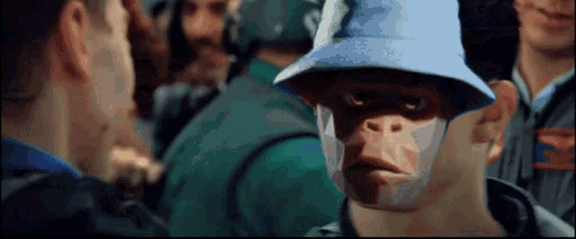 a man in a blue hat has a monkey face on his face