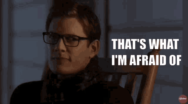 a man wearing glasses is sitting in a rocking chair with the words that 's what i 'm afraid of above him
