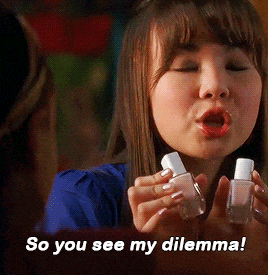 a woman is holding two bottles of nail polish with the words so you see my dilemma below her