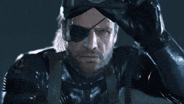 a man with a beard and an eye patch is wearing a black leather suit and gloves .