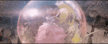 a ballerina in a pink dress is dancing in a snow globe