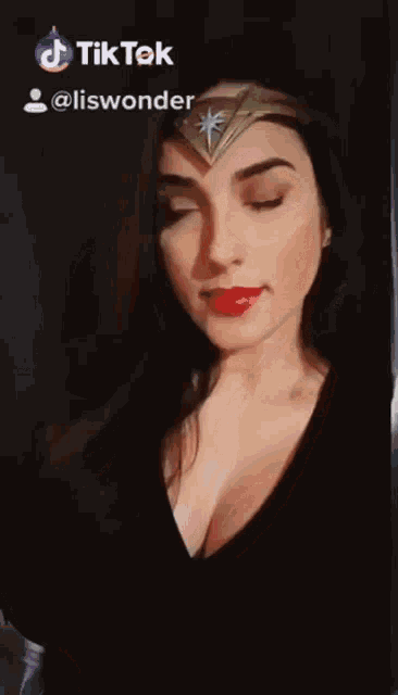 a woman wearing a wonder woman costume has a tik tok icon above her