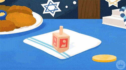 a wooden dreidel with the letter n on it is on a napkin on a table