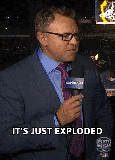 a man in a suit and tie is holding a microphone that says nbcsn