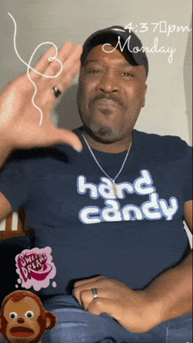 a man wearing a blue shirt that says hard candy