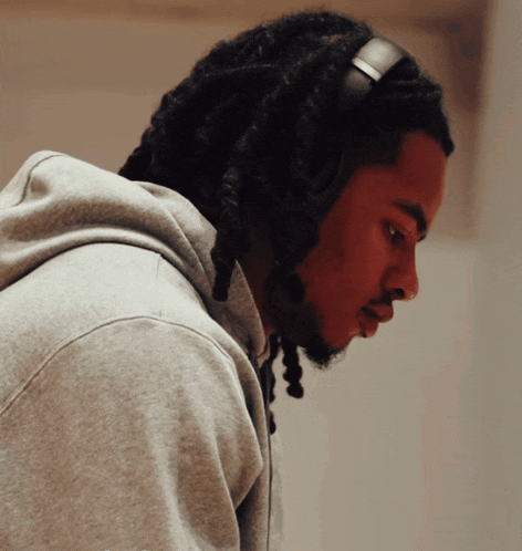 a man with dreadlocks is wearing headphones