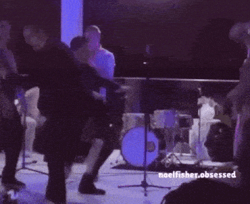 a group of people are dancing in a dark room and the words noelfisher.obsessed are above them