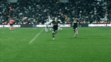 a soccer game is being played on a field with advertisements for miras