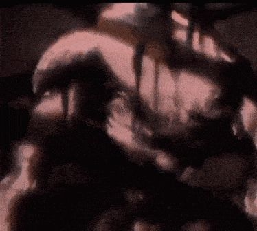 a blurred image of a person 's torso with a black background