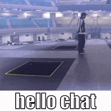a man is standing on a stage in an empty stadium with the words hello chat below him