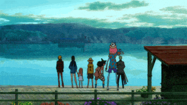 a group of people standing in front of a body of water with a cat on stilts