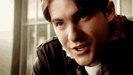 a close up of a young man 's face smiling .