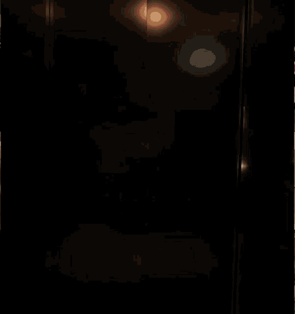 a woman in a pink dress is standing in an elevator with the number 4 on the wall