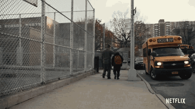 a yellow school bus is parked on the side of a street