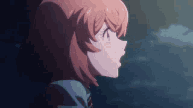 a close up of a girl 's face with red hair and a blue background .