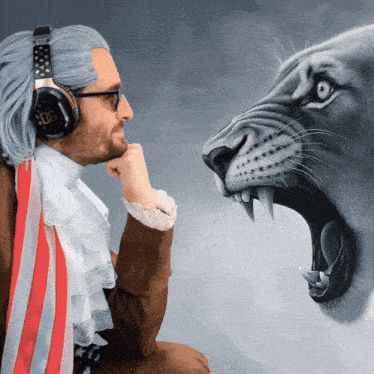 a man wearing headphones is looking at a painting of a lion with its mouth open