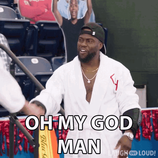 a man in a robe shakes hands with another man and says " oh my god man "