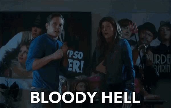 a man and woman are standing in front of a sign that says bloody hell