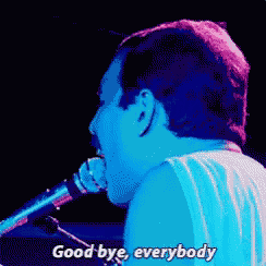 a man is singing into a microphone and saying good bye everybody