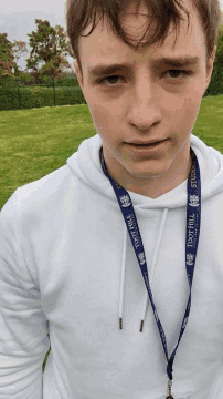 a man wearing a lanyard that says toot hill