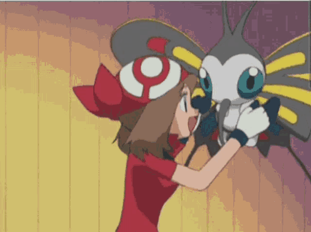 a girl in a red shirt is holding a butterfly in her hands