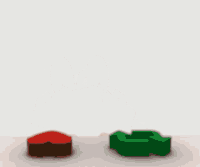 a cartoon girl is sitting on a table with two blocks .