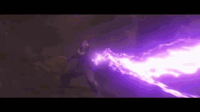 a purple light is coming from a person 's hand