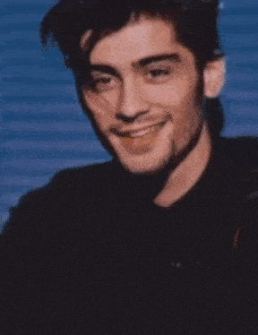 a blurry picture of a man with a bottle of oxo in the background