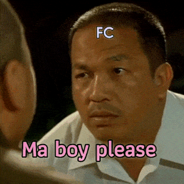 a man talking to another man with a fc logo on his head