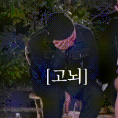 a man in a suit is kneeling down with a canadian flag on his knee .