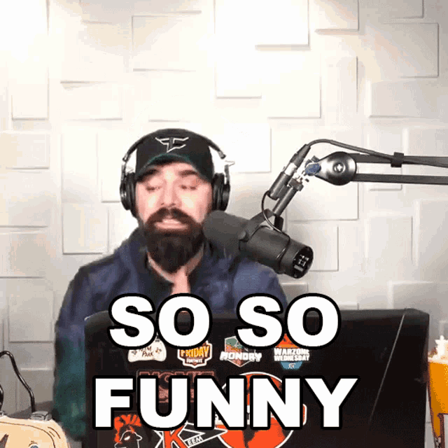 a man wearing headphones stands in front of a microphone and says so so funny
