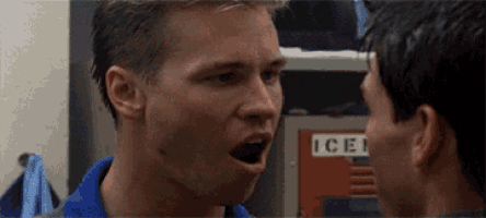 two men are talking in front of a locker that says ice on it