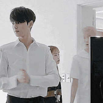 a man in a white shirt is standing in front of a woman