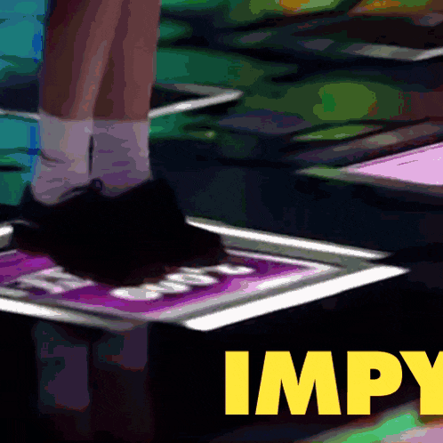 a person 's foot is on a sign that says " impy "