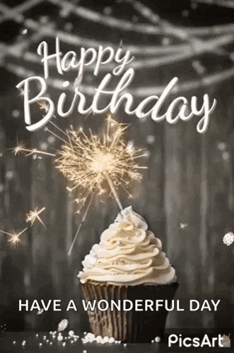 a cupcake with whipped cream and a sparkler on top of it .
