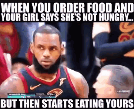 a basketball player with a beard is standing in front of a crowd while a woman says she is not hungry