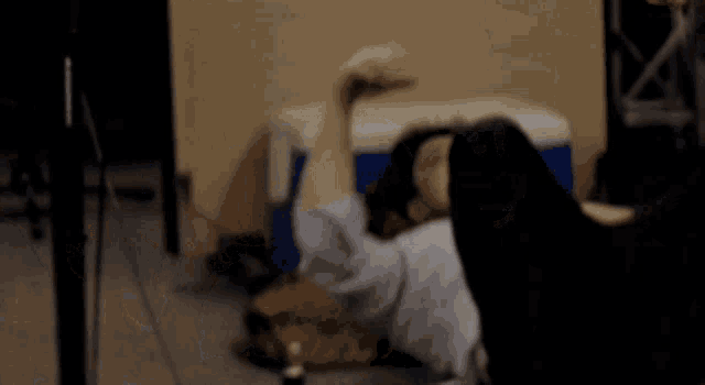 a blurry image of a person laying on the floor