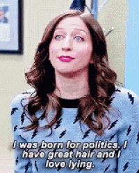 a woman is wearing a sweater with lightning bolts on it and is saying i was born for politics .