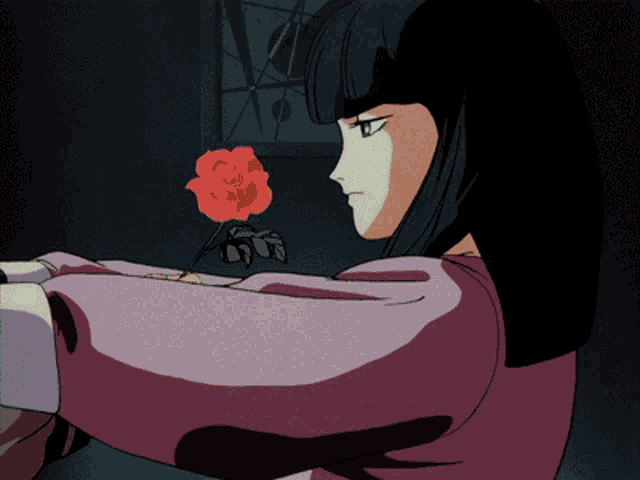 a woman in a pink shirt is holding a red rose in her hand