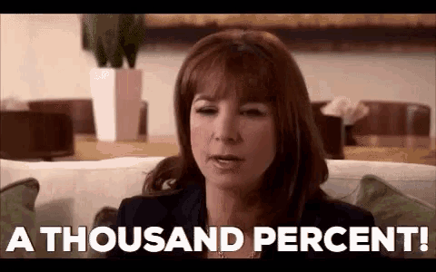 a woman is sitting on a couch and says `` a thousand percent ! ''