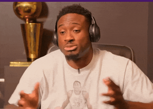 a man wearing headphones and a shirt with a picture of a basketball player with the number 33