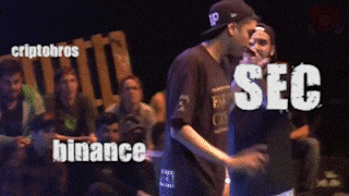 two men are dancing in front of a crowd and the words sec are visible