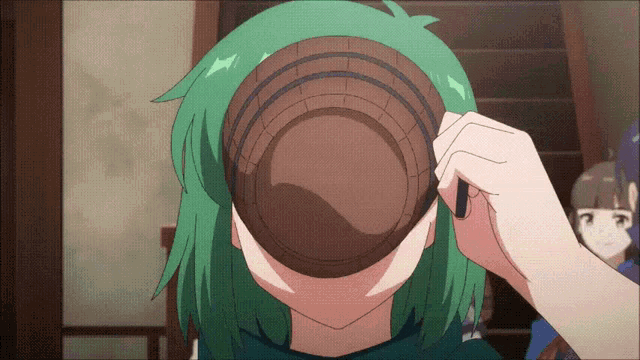 a girl with green hair is holding a bowl over her face