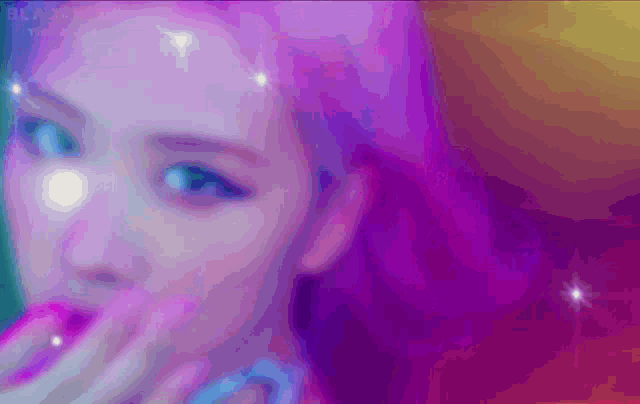 a close up of a woman 's face with a purple and blue background