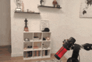 a blurry picture of a room with a shelf and a red object in the foreground